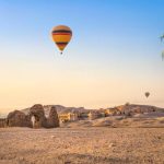 Hot air balloon over ruins of Hatshepsut temple in Luxor, Egypt