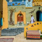 A Nubian man walks outside a traditional Nubian house, Aswan Egypt, August 2015