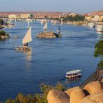 Beautiful landscape with felucca boats on Nile river in Aswan at sunset, Egypt