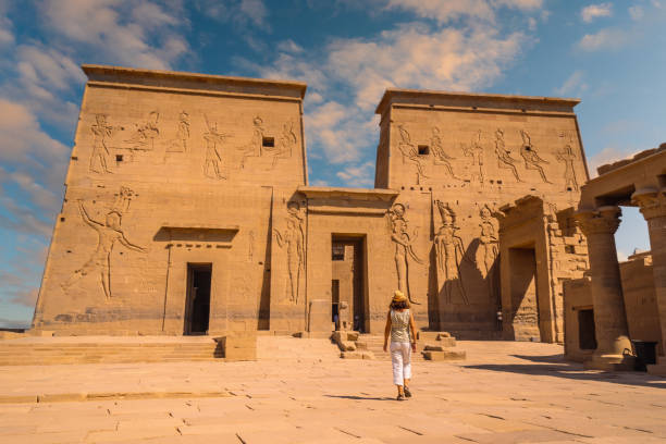 A young tourist visiting the Temple of Philae - shot from behind