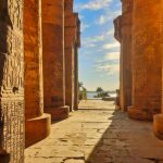 Picturesque view of the grand columns with reliefs with a view of the Nile river at the Temple of Sobek and Haroeris built in 2nd century BC by Ptolemy pharoahs in Kom Ombo,Near Aswan,Egypt