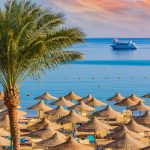 Relaxing at paradise beach - Chaise lounge and parasols - travel destination Hurghada, Egypt