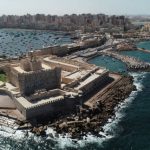 Aerial Drone shot over Egypt Alexandria City sea - The Citadel of Qaitbay