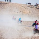 Tourism holidy sport activity, desert safary ride on off road 4x4 buggy bike, joyful happy people enjoy extreme fun time, shot selective focus with sahllow depth of field, Cairo Egypt on 15 june 2015