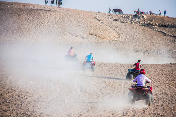 Tourism holidy sport activity, desert safary ride on off road 4x4 buggy bike, joyful happy people enjoy extreme fun time, shot selective focus with sahllow depth of field, Cairo Egypt on 15 june 2015