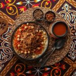 Egyptian cuisine of Koshary, a popular street food made of rice, macaroni, spaghetti and lentils mixed together topped with a spiced tomato sauce, garlic vinegar, fried onions and hummus chickpeas